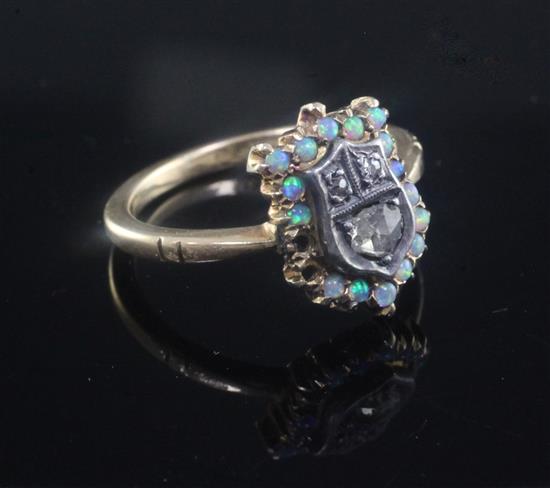 An Edwardian 18ct gold, white opal and rose cut diamond set shield shaped ring, size L.